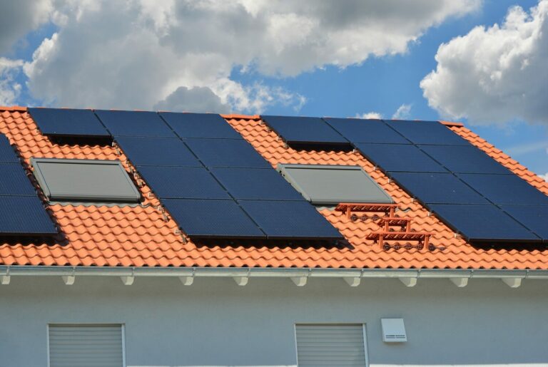 Installation de panneaux solaires thermiques par PC Rénovation sur le toit d'une maison individuelle avec des briques